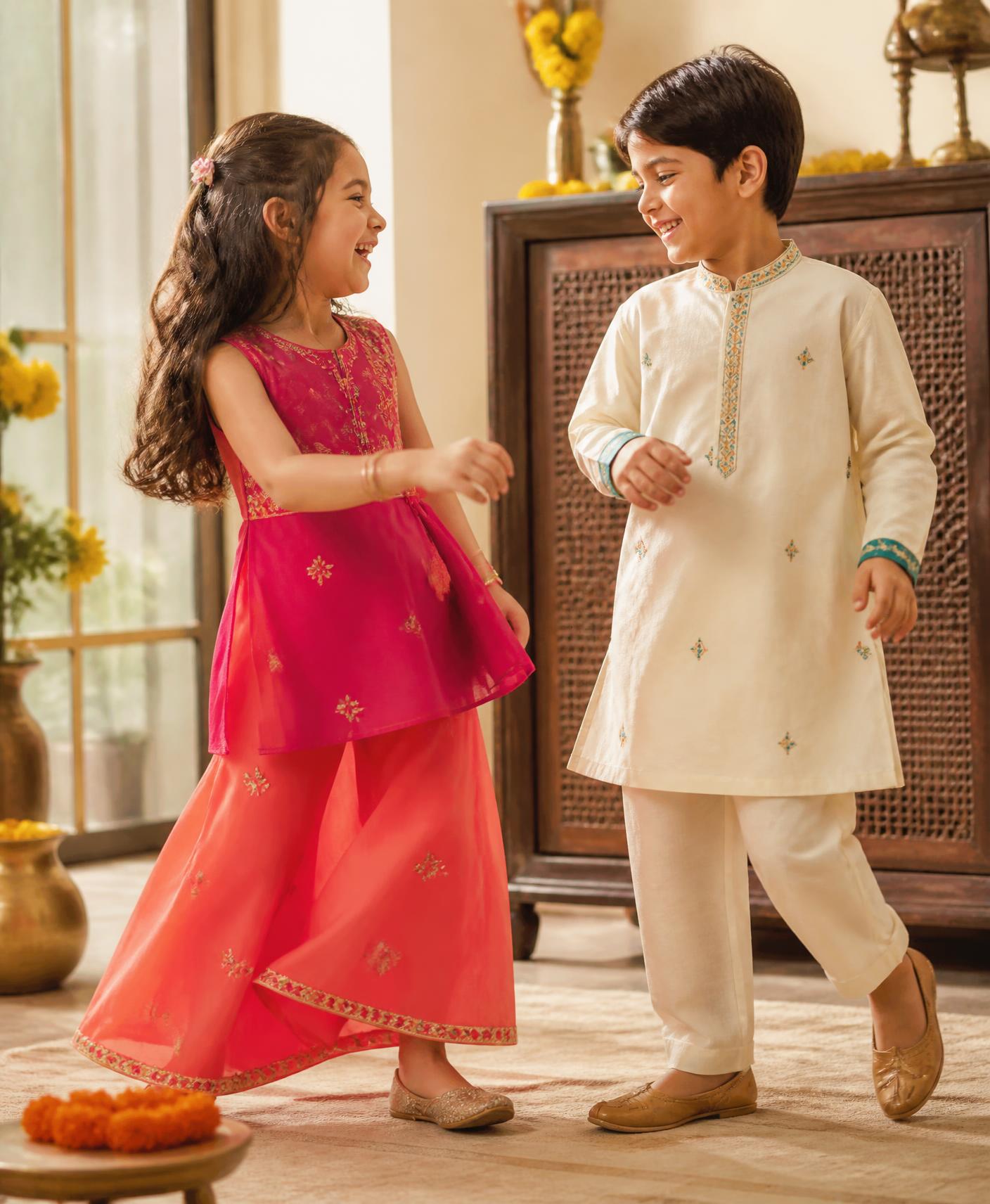 Two joyful Indian children in colourful contemporary festive Mini Mellow outfits